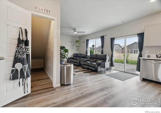608 Apex Trl, Ault, CO 80610 - living room with light wood-style flooring, a ceiling fan, and baseboards