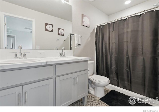608 Apex Trl, Ault, CO 80610 - bathroom with toilet, double vanity, tile patterned floors, and a shower with curtain