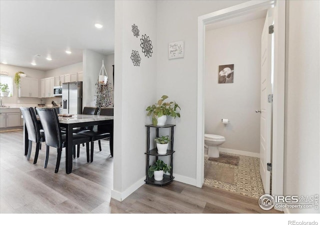 608 Apex Trl, Ault, CO 80610 - dining room with light wood-style flooring, baseboards, and recessed lighting