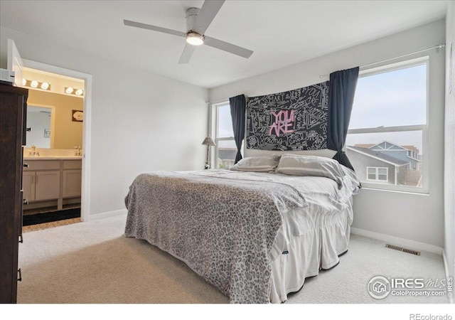 608 Apex Trl, Ault, CO 80610 - carpeted bedroom with baseboards, a ceiling fan, and ensuite bathroom