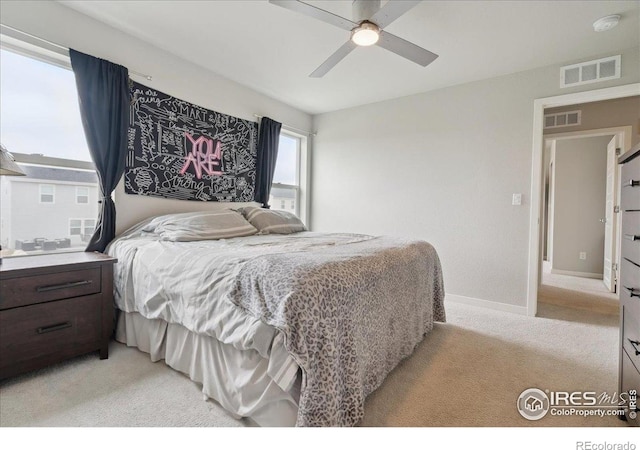 608 Apex Trl, Ault, CO 80610 - bedroom with light carpet, baseboards, and ceiling fan