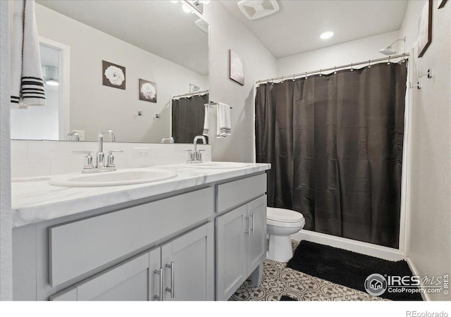 608 Apex Trl, Ault, CO 80610 - bathroom with double vanity, toilet, and a shower with curtain