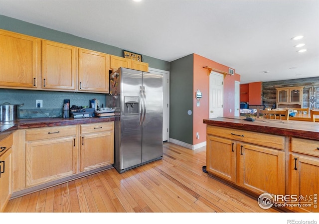 1086 Mockingbird St, Brighton, CO 80601 - kitchen featuring stainless steel refrigerator with ice dispenser, baseboards, light wood-style flooring, dark countertops, and recessed lighting