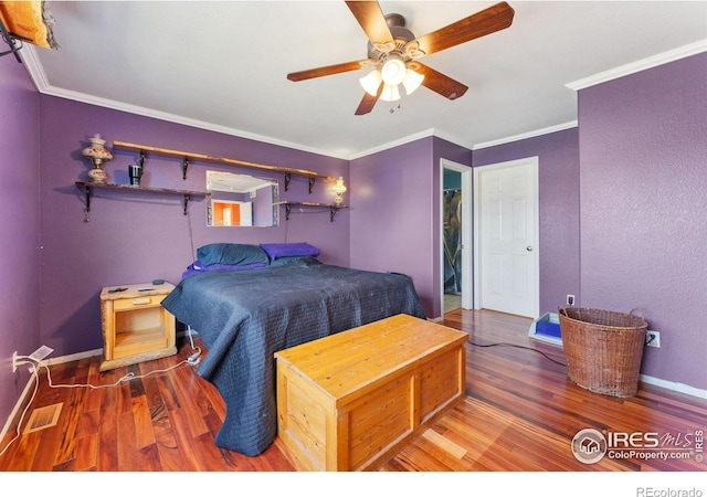 1086 Mockingbird St, Brighton, CO 80601 - bedroom featuring wood finished floors, crown molding, ceiling fan, and baseboards