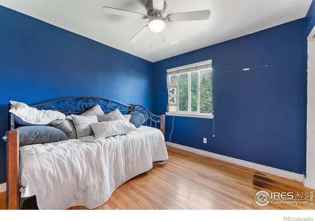 1086 Mockingbird St, Brighton, CO 80601 - bedroom with wood finished floors, baseboards, and a ceiling fan