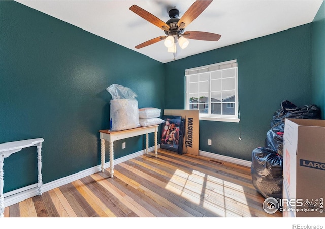 1086 Mockingbird St, Brighton, CO 80601 - bedroom with hardwood / wood-style floors, baseboards, ceiling fan, and a textured wall
