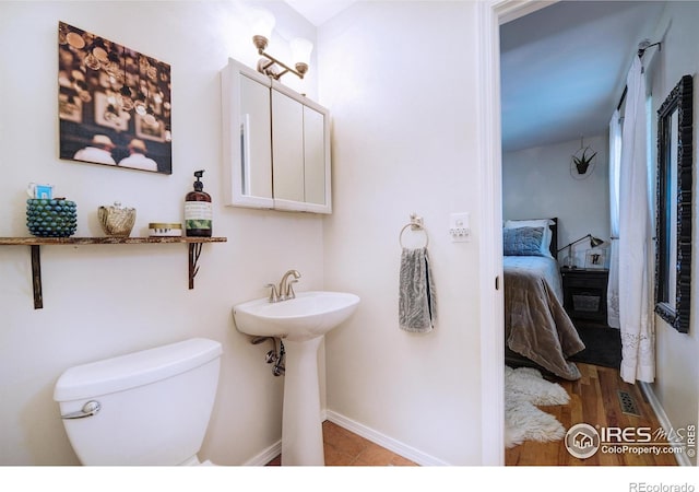 855 33rd St, Boulder, CO 80303 - bathroom featuring connected bathroom, toilet, and baseboards