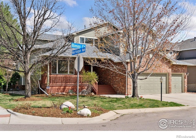 4094 Bimini Ct, Boulder, CO 80301 - view of front of home with concrete driveway, brick siding, a front lawn, and a balcony