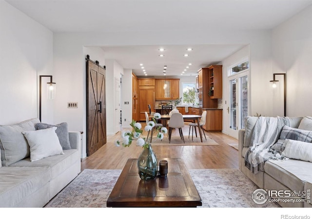 4094 Bimini Ct, Boulder, CO 80301 - living area with a barn door, recessed lighting, light wood-style floors, and baseboards