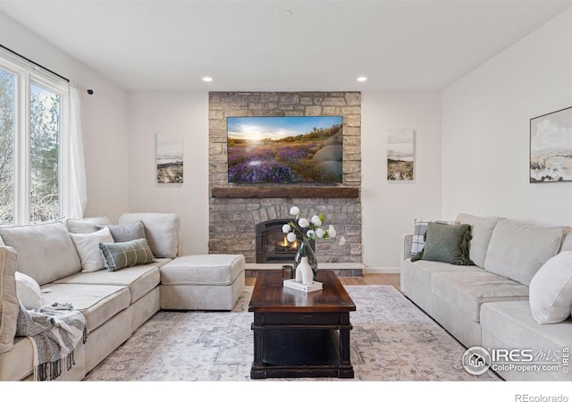 4094 Bimini Ct, Boulder, CO 80301 - living area with wood finished floors, recessed lighting, a stone fireplace, and baseboards