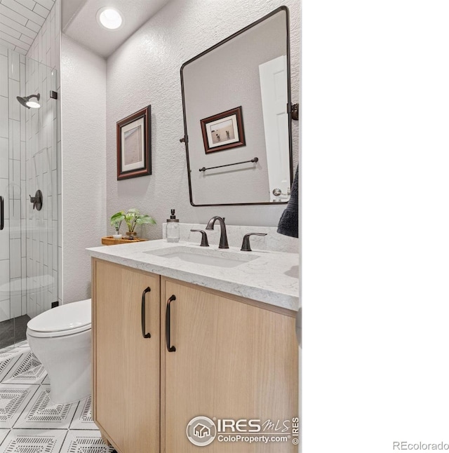 4094 Bimini Ct, Boulder, CO 80301 - full bath featuring vanity, toilet, a shower stall, tile patterned flooring, and a textured wall