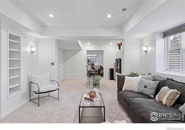 4094 Bimini Ct, Boulder, CO 80301 - living room featuring a lit fireplace, light carpet, built in shelves, recessed lighting, and baseboards