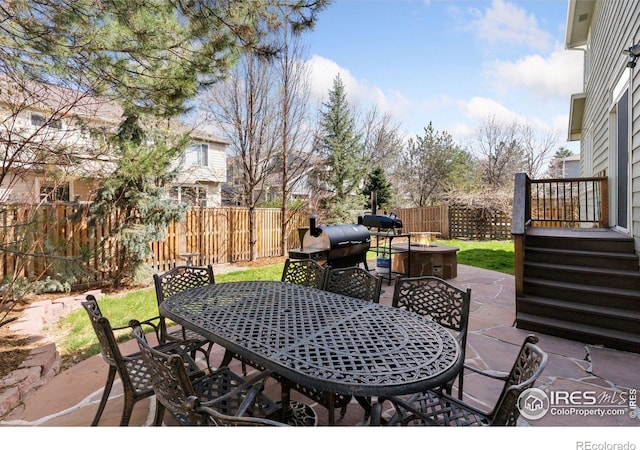 4094 Bimini Ct, Boulder, CO 80301 - fenced backyard featuring outdoor dining area, a fire pit, a patio area, and area for grilling