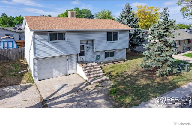 8208 Peakview Dr, Fort Collins, CO 80528 - raised ranch featuring central air condition unit, a garage, asphalt driveway, and a shingled roof