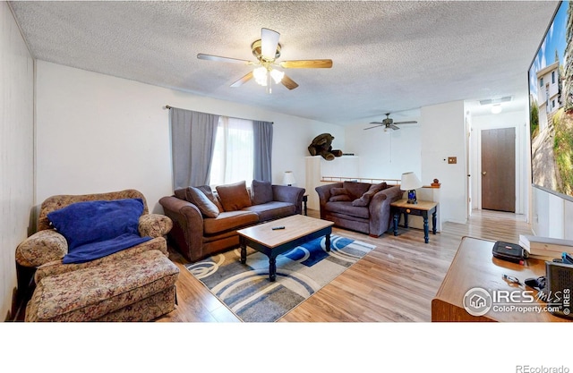 8208 Peakview Dr, Fort Collins, CO 80528 - living area with a ceiling fan, light wood-style floors, and a textured ceiling