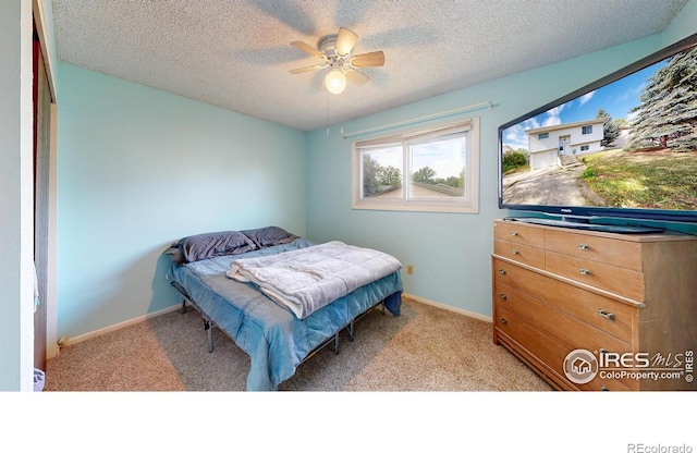 8208 Peakview Dr, Fort Collins, CO 80528 - bedroom with light colored carpet, a textured ceiling, ceiling fan, and baseboards
