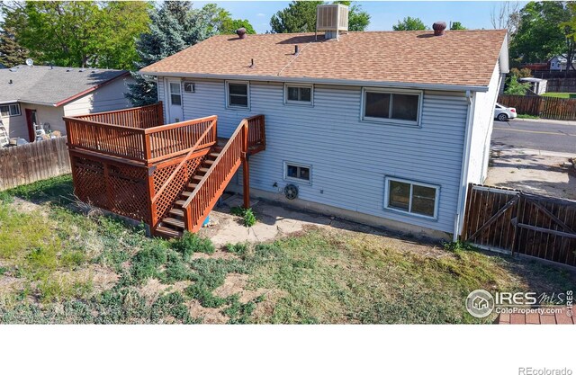 8208 Peakview Dr, Fort Collins, CO 80528 - rear view of house with a wooden deck, a fenced backyard, stairs, a shingled roof, and cooling unit