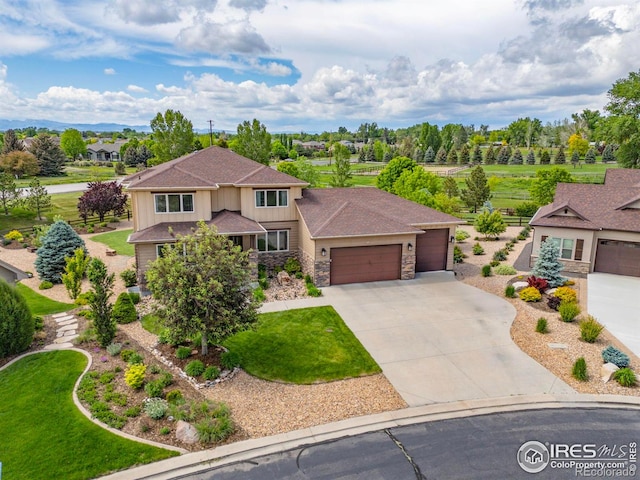 873 Signal Ct, Timnath, CO 80547 - view of front of house with a garage, stone siding, board and batten siding, and driveway