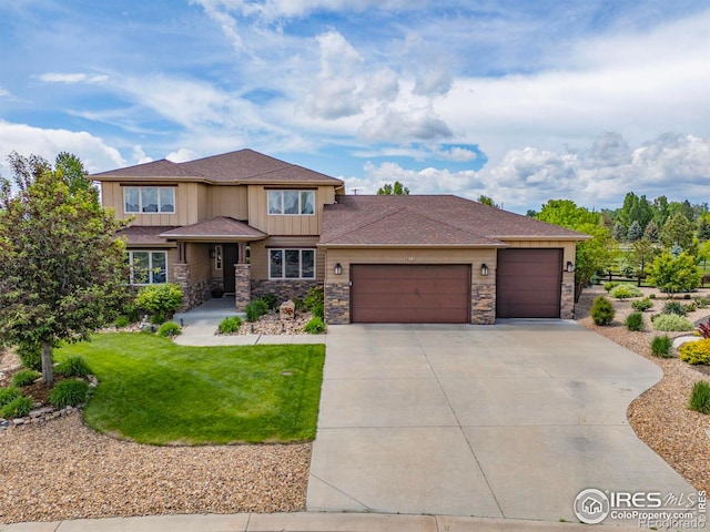 873 Signal Ct, Timnath, CO 80547 - prairie-style home featuring stone siding, an attached garage, driveway, and board and batten siding