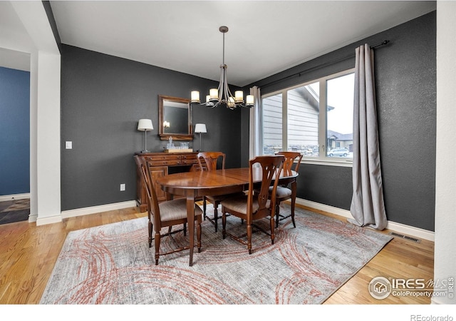 873 Signal Ct, Timnath, CO 80547 - dining area with wood finished floors, a chandelier, and baseboards