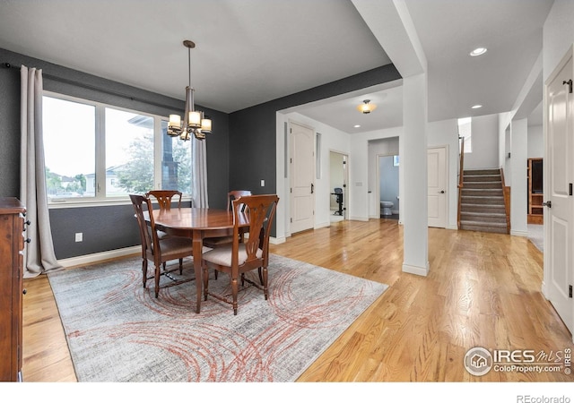 873 Signal Ct, Timnath, CO 80547 - dining room with baseboards, light wood finished floors, a chandelier, stairway, and recessed lighting