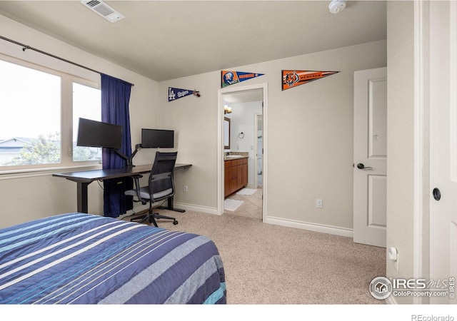 873 Signal Ct, Timnath, CO 80547 - bedroom with light colored carpet, baseboards, and ensuite bath
