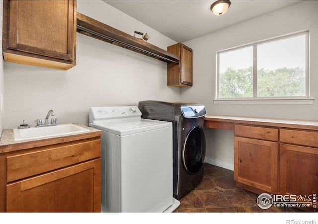 873 Signal Ct, Timnath, CO 80547 - laundry room with cabinet space, independent washer and dryer, baseboards, and dark tile patterned floors