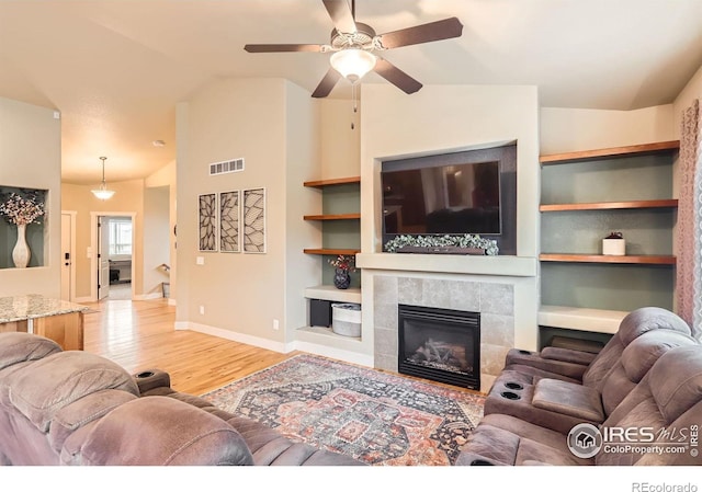 405 Timber Ridge Parkway, Severance, CO 80550 - living area with wood finished floors, vaulted ceiling, baseboards, a fireplace, and ceiling fan