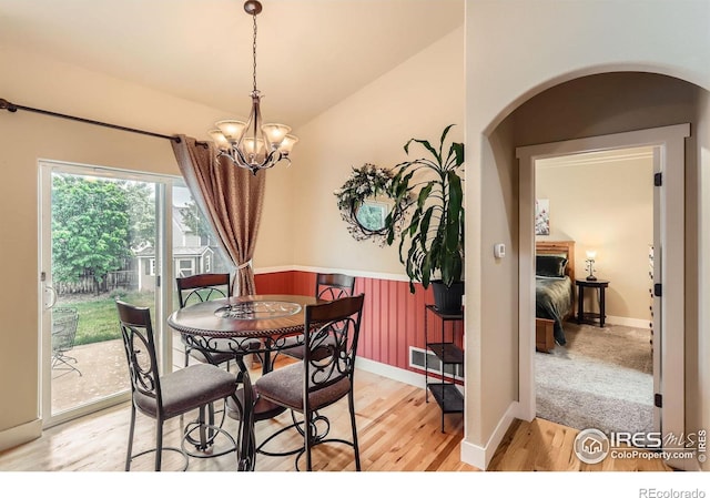 405 Timber Ridge Parkway, Severance, CO 80550 - dining room featuring light wood-type flooring, a chandelier, arched walkways, baseboards, and vaulted ceiling