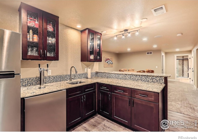 405 Timber Ridge Parkway, Severance, CO 80550 - kitchen with freestanding refrigerator, a sink, a peninsula, light wood finished floors, and refrigerator