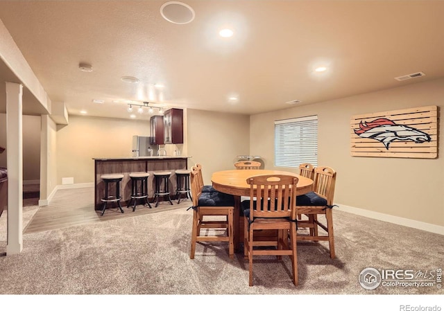 405 Timber Ridge Parkway, Severance, CO 80550 - dining space with light carpet, a dry bar, recessed lighting, and baseboards