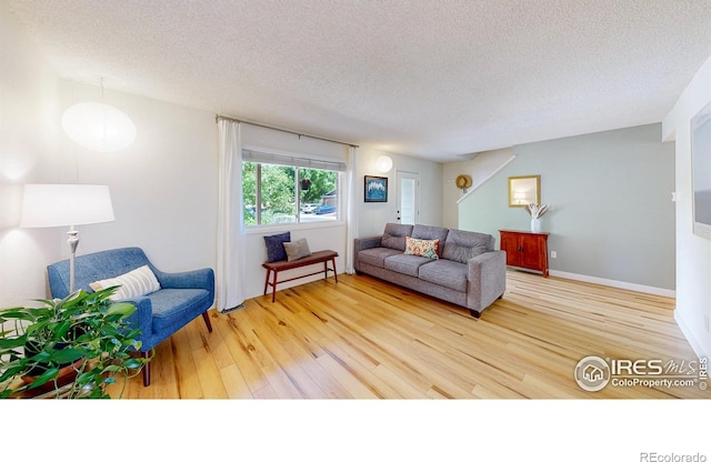 2415 Sunray Ct, Fort Collins, CO 80525 - living room featuring wood finished floors and a textured ceiling