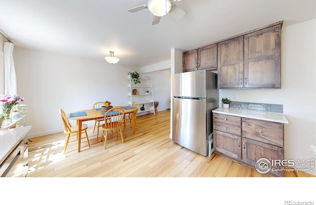 2415 Sunray Ct, Fort Collins, CO 80525 - kitchen with freestanding refrigerator, light wood-style flooring, ceiling fan, and light countertops