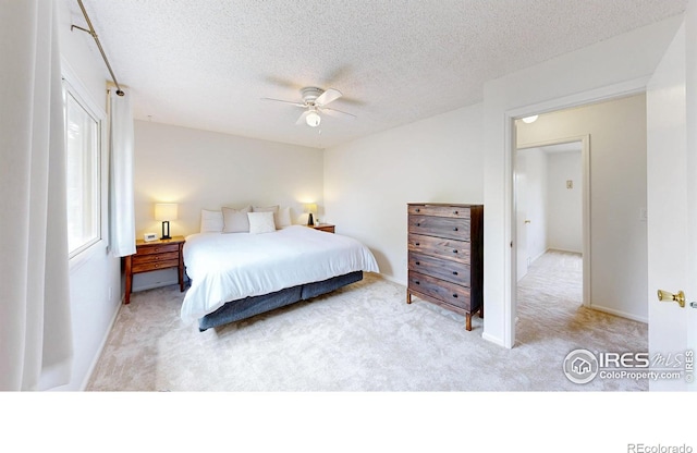 2415 Sunray Ct, Fort Collins, CO 80525 - bedroom featuring light carpet, a textured ceiling, a ceiling fan, and baseboards