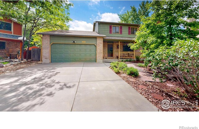 2415 Sunray Ct, Fort Collins, CO 80525 - traditional home with concrete driveway, an attached garage, covered porch, and brick siding
