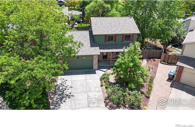 2415 Sunray Ct, Fort Collins, CO 80525 - view of front facade featuring a shingled roof, brick siding, driveway, and an attached garage
