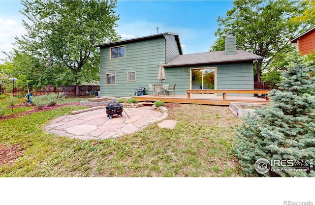 2415 Sunray Ct, Fort Collins, CO 80525 - rear view of house with a fire pit, a deck, a chimney, and a patio area