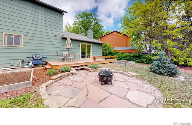 2415 Sunray Ct, Fort Collins, CO 80525 - view of patio featuring a fire pit, a wooden deck, grilling area, and outdoor dining area