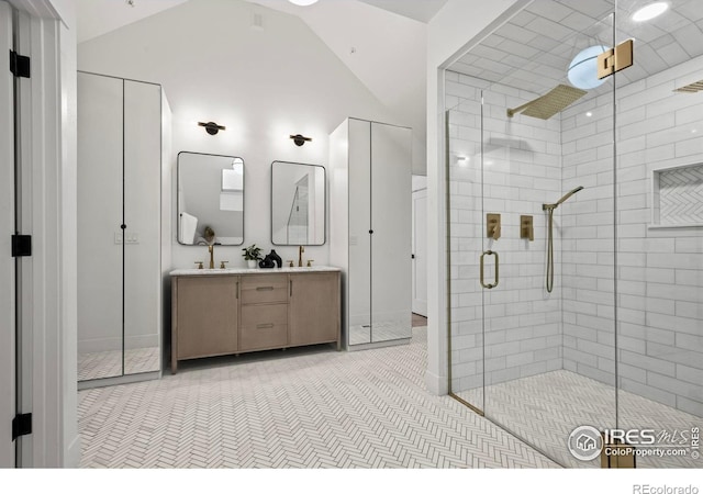 2434 Mapleton Ave, Boulder, CO 80304 - bathroom featuring a shower stall, double vanity, vaulted ceiling, and baseboards