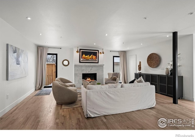 2434 Mapleton Ave, Boulder, CO 80304 - living area with a warm lit fireplace, wood finished floors, recessed lighting, and baseboards
