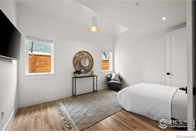 2434 Mapleton Ave, Boulder, CO 80304 - bedroom featuring multiple windows, wood finished floors, and baseboards