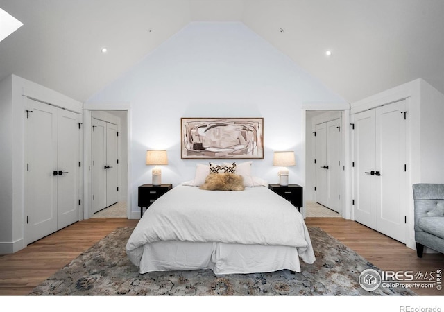 2434 Mapleton Ave, Boulder, CO 80304 - bedroom featuring multiple closets, wood finished floors, high vaulted ceiling, and recessed lighting
