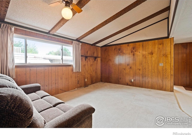 1155 Caroline Ct, Loveland, CO 80537 - living area with wood walls, a ceiling fan, a textured ceiling, and carpet floors