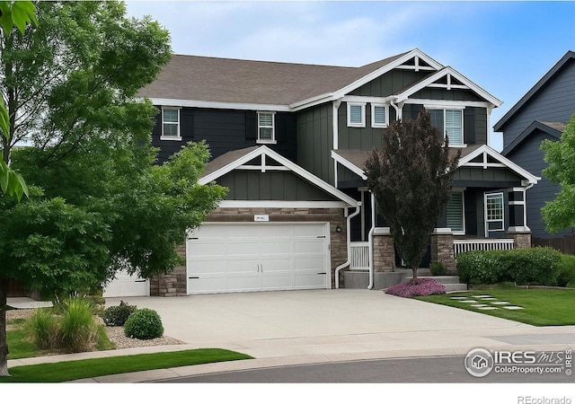 6434 Cloudburst Ave, Timnath, CO 80547 - craftsman-style home with board and batten siding, stone siding, concrete driveway, and a porch