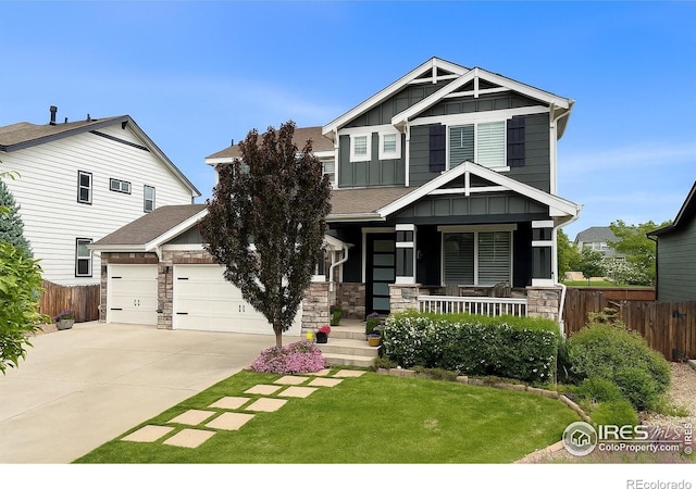 6434 Cloudburst Ave, Timnath, CO 80547 - craftsman house with board and batten siding, covered porch, concrete driveway, an attached garage, and stone siding