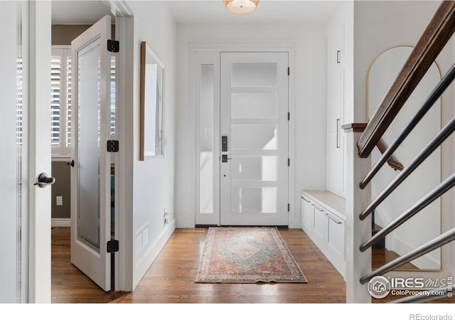 6434 Cloudburst Ave, Timnath, CO 80547 - foyer entrance with wood finished floors, stairs, and baseboards
