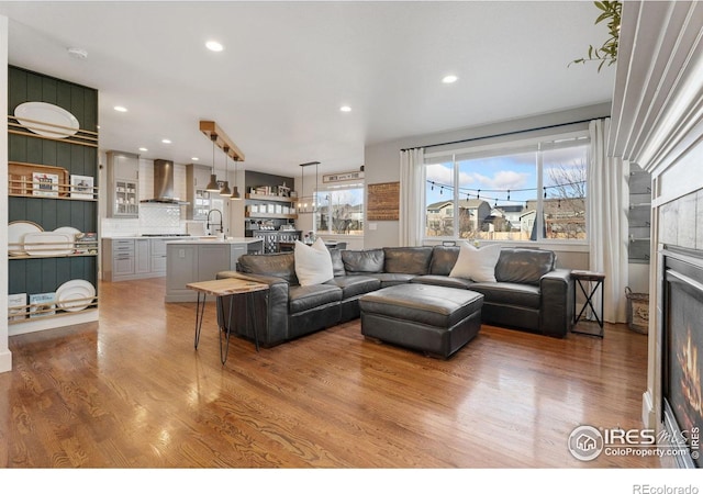 6434 Cloudburst Ave, Timnath, CO 80547 - living area featuring wood finished floors and recessed lighting