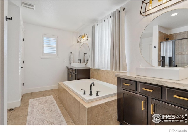 6434 Cloudburst Ave, Timnath, CO 80547 - bathroom featuring a garden tub, vanity, tile patterned flooring, a tile shower, and baseboards