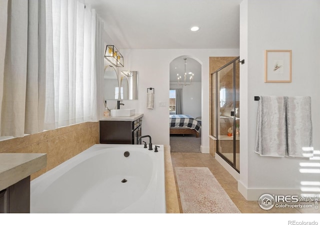 6434 Cloudburst Ave, Timnath, CO 80547 - ensuite bathroom featuring a bath, a shower stall, vanity, and recessed lighting