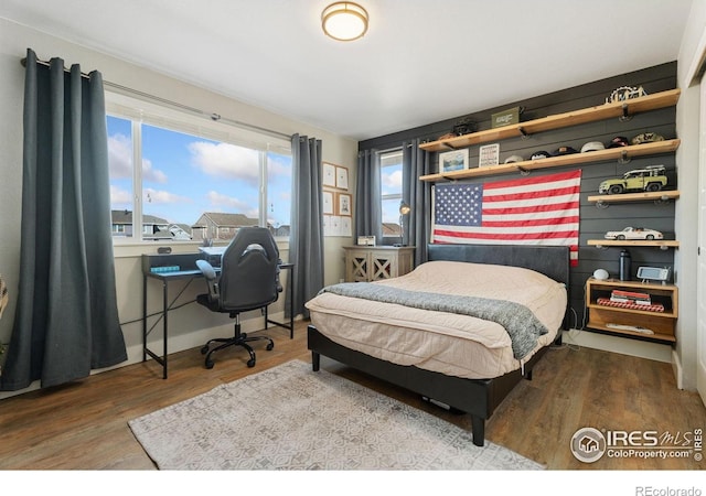 6434 Cloudburst Ave, Timnath, CO 80547 - bedroom featuring wood finished floors and a desk